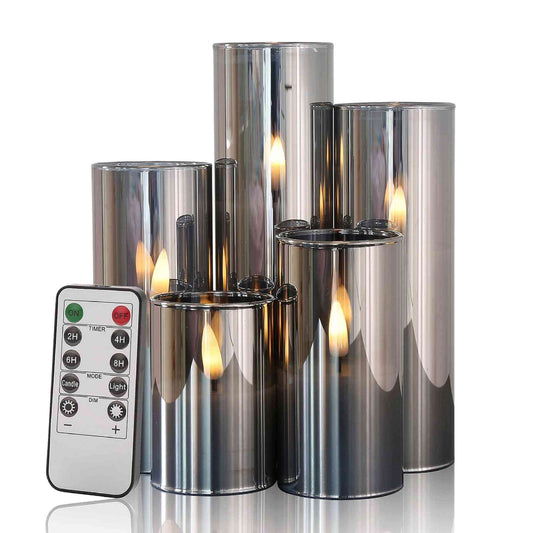 A set of 5 flameless gray glass candles in different lengths and a remote