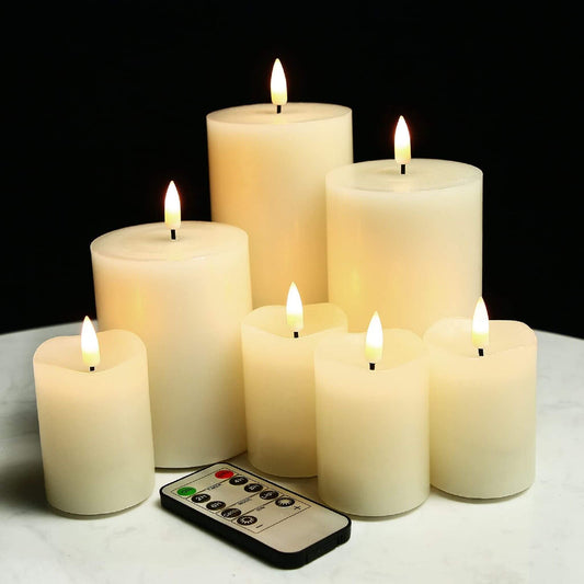 set of 7 flameless votive pillar candles with a remote, varying in length, placed on a table