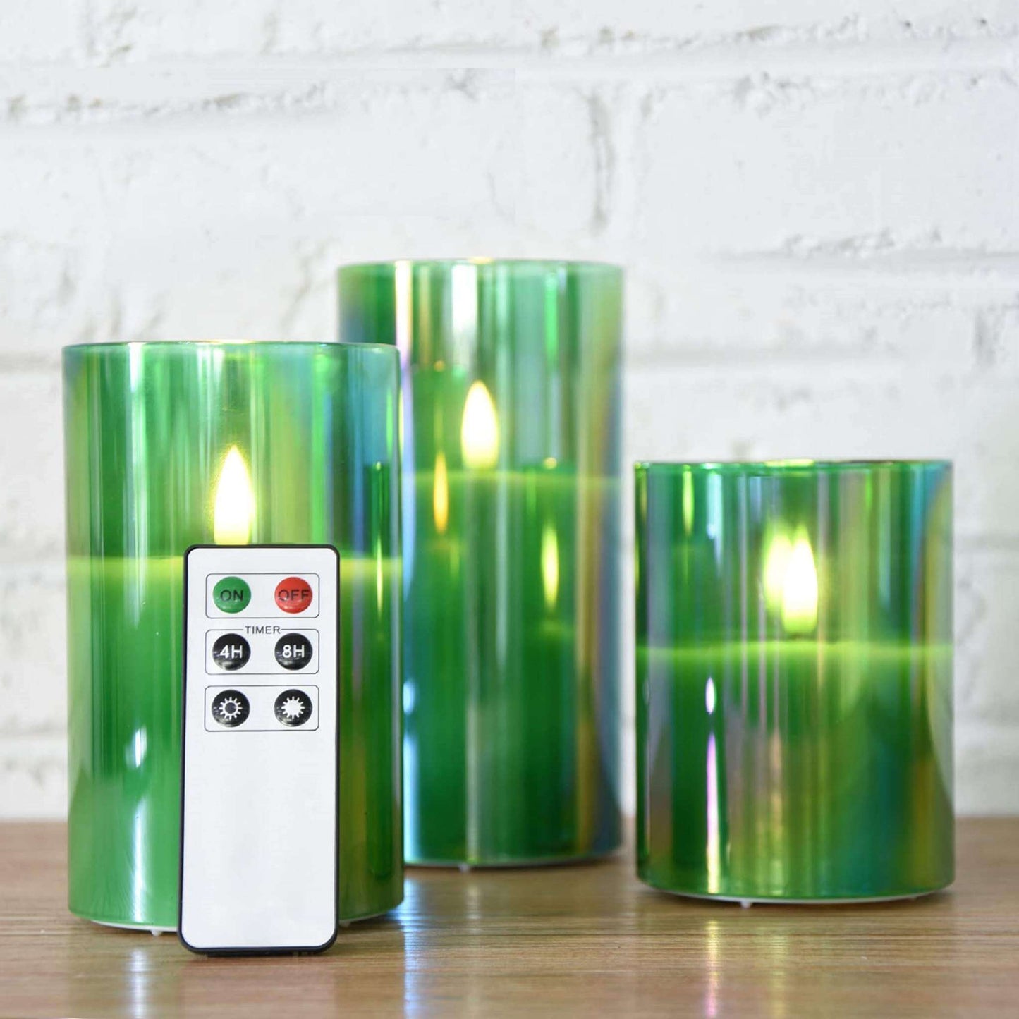 3 eywamage green glass flameless candles with a remote on the table