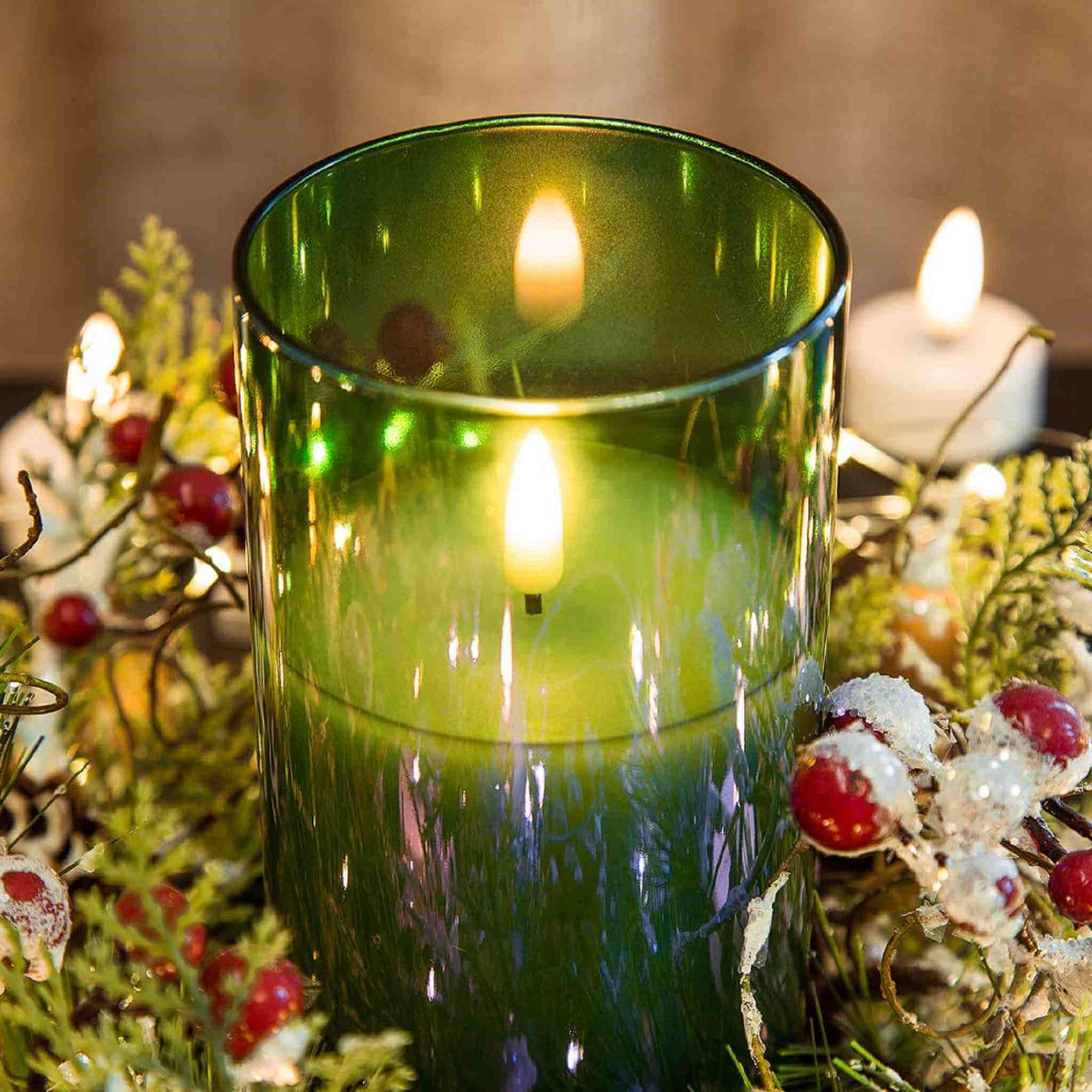 An eywamage green glass flameless candle is placed on some green plants, with some red fruits and led tea light decoration