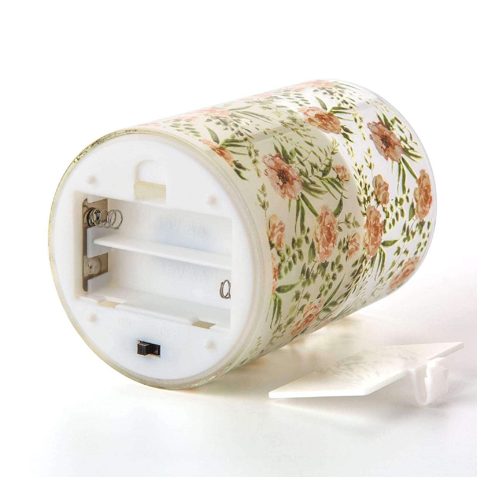 The bottom of an eywamage floral glass flameless candles is opened, showing that it needs 2 AA batteries