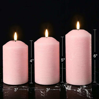 Three blush pink flameless pillar candles are placed on a marble table. Their diameter is 3 inches and their heights are 4, 5, and 6 inches.