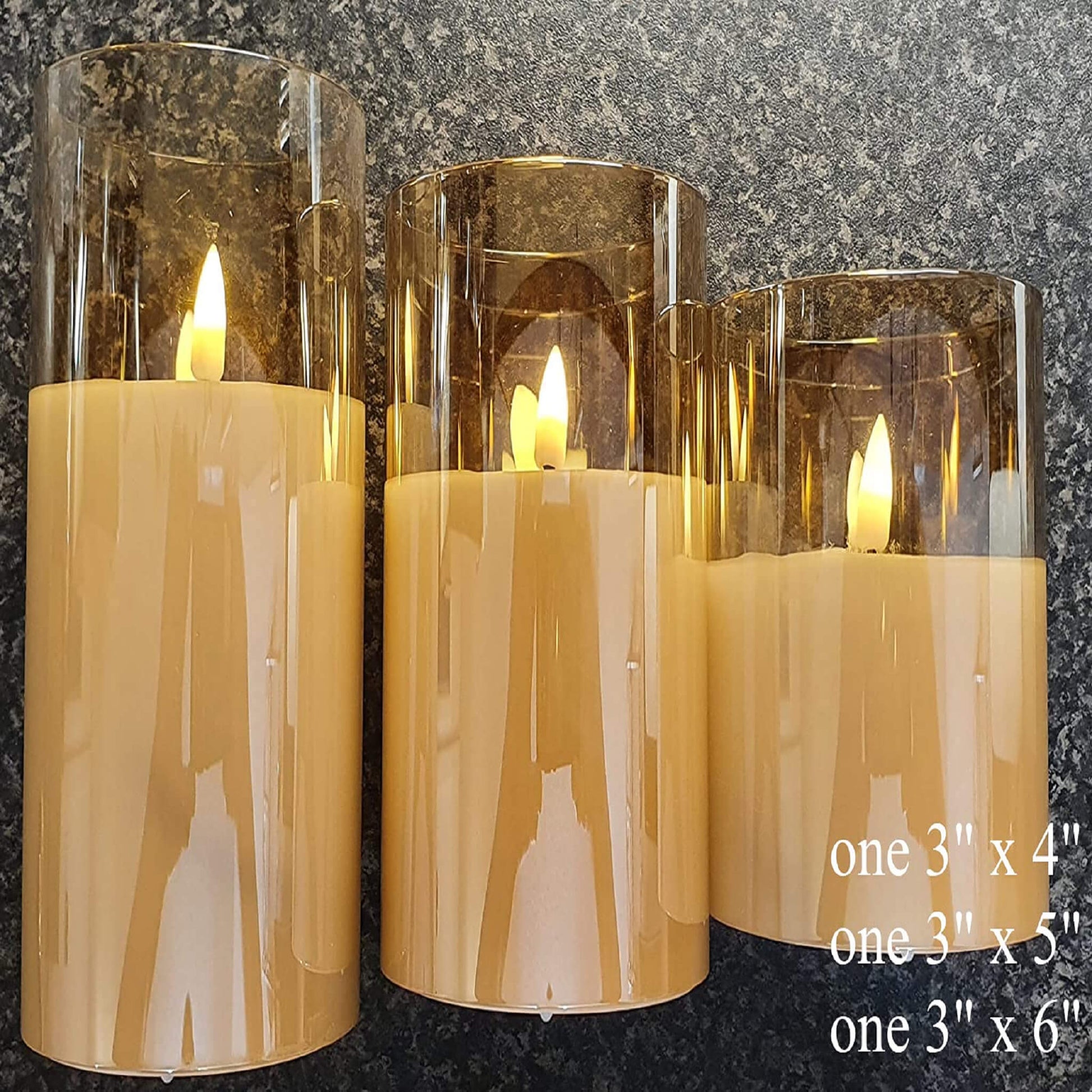 Three eywamage gold glass flameless candles are placed flat on a black table, they are all 3 inches in diameter and 4, 5, 6 inches in height.