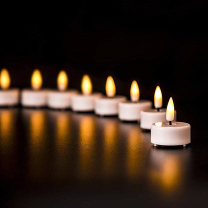 8 white electronic tea lights placed in an arc on a black tabletop