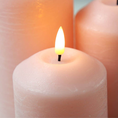 blush pink flameless candles with magnified focus on their tops and wicks